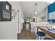 Open kitchen with wood floors, stainless steel appliances, an island, and modern light fixtures at 579 Juniper Way, Tavares, FL 32778
