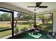 Relaxing screened lanai offering tranquil outdoor views and a comfortable seating area at 579 Juniper Way, Tavares, FL 32778
