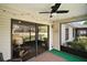 Cozy screened lanai with a ceiling fan and sliding glass doors, perfect for indoor-outdoor living at 579 Juniper Way, Tavares, FL 32778