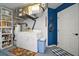 Functional laundry area with washer, dryer, shelving, and easy access to the exterior at 579 Juniper Way, Tavares, FL 32778