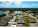 Scenic aerial view of homes in a peaceful neighborhood around a tranquil lake with mature trees at 5818 Greenbriar Loop, Leesburg, FL 34788