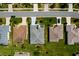 Bird's eye view of homes featuring green lawns and mature landscaping in a well-kept neighborhood at 5818 Greenbriar Loop, Leesburg, FL 34788