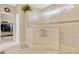Modern bathroom showcasing a glass shower and access to a walk-in closet at 5818 Greenbriar Loop, Leesburg, FL 34788