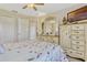 Comfortable bedroom featuring floral bedding, dresser, and a ceiling fan at 5818 Greenbriar Loop, Leesburg, FL 34788