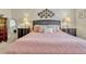 Comfortable bedroom with two nightstands and unique wall decor above the bed at 5818 Greenbriar Loop, Leesburg, FL 34788