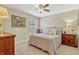 Cozy bedroom with plush carpeting, neutral walls, and coordinated furnishings at 5818 Greenbriar Loop, Leesburg, FL 34788