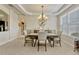 An elegant dining room featuring modern chandelier and tray ceiling at 5818 Greenbriar Loop, Leesburg, FL 34788