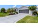 Close up of a spacious driveway with decorative inlays leading to an attached garage at 5818 Greenbriar Loop, Leesburg, FL 34788