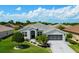Beautiful single story home with well-manicured landscaping and a spacious driveway at 5818 Greenbriar Loop, Leesburg, FL 34788