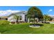 Charming single-story home with a well-manicured lawn and lush landscaping at 5818 Greenbriar Loop, Leesburg, FL 34788