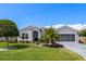 Beautiful single story home with well-manicured landscaping and a charming front yard at 5818 Greenbriar Loop, Leesburg, FL 34788
