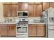Modern kitchen with stainless steel appliances, granite countertops and ample storage space at 5818 Greenbriar Loop, Leesburg, FL 34788