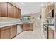 Modern kitchen with stainless steel appliances, granite countertops and tiled floors at 5818 Greenbriar Loop, Leesburg, FL 34788