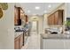 Bright kitchen with stainless appliances, granite counters, and ample cabinet space at 5818 Greenbriar Loop, Leesburg, FL 34788