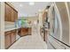 Modern kitchen with stainless steel appliances, granite countertops and tiled floors at 5818 Greenbriar Loop, Leesburg, FL 34788