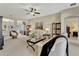 Spacious living room featuring neutral tones, a ceiling fan, and an open layout at 5818 Greenbriar Loop, Leesburg, FL 34788
