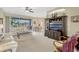 Bright living room with large windows, comfortable seating, and an open layout at 5818 Greenbriar Loop, Leesburg, FL 34788