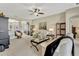 Spacious living room featuring neutral tones, a ceiling fan, and an open layout at 5818 Greenbriar Loop, Leesburg, FL 34788