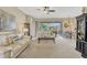 Open-concept living room featuring stylish furnishings and access to an outdoor patio at 5818 Greenbriar Loop, Leesburg, FL 34788