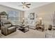 Cozy living room featuring plush furniture, natural light, and neutral decor at 5818 Greenbriar Loop, Leesburg, FL 34788