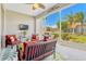 Relaxing screened-in patio with comfortable seating and a beautiful backyard view at 5818 Greenbriar Loop, Leesburg, FL 34788