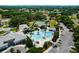 Stunning community pool with tennis courts, lush landscaping, and ample parking spaces at 5818 Greenbriar Loop, Leesburg, FL 34788