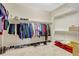 Walk-in closet with ample storage space and organized shelving for clothes and shoes at 5818 Greenbriar Loop, Leesburg, FL 34788