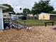 Expansive backyard featuring a bridge, lush greenery, rock landscaping, a well-maintained lawn and playful dog at 604 N Old Wire Rd, Wildwood, FL 34785