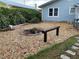 Backyard with a rustic fire pit area and stone landscape, great for outdoor entertaining in a cozy setting at 604 N Old Wire Rd, Wildwood, FL 34785