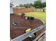 Landscaped backyard with wood privacy fence and fresh mulch, perfect for outdoor relaxation at 604 N Old Wire Rd, Wildwood, FL 34785