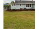 Home exterior featuring a well-manicured grassy lawn and landscape around the exterior of the home at 604 N Old Wire Rd, Wildwood, FL 34785