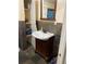 Bathroom features a stylish vanity with a vessel sink and convenient open shelving for storage at 604 N Old Wire Rd, Wildwood, FL 34785
