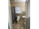This bathroom showcases a tiled floor, toilet, and pedestal sink, offering essential functionality at 604 N Old Wire Rd, Wildwood, FL 34785