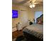 Cozy bedroom with hardwood floors, a ceiling fan, and a built-in desk area at 604 N Old Wire Rd, Wildwood, FL 34785