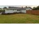 Well-maintained home features a lush green lawn, well-placed landscaping and a privacy fence at 604 N Old Wire Rd, Wildwood, FL 34785