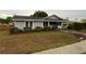 Charming single story home with light blue siding and well-manicured landscaping around the front at 604 N Old Wire Rd, Wildwood, FL 34785