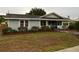 Charming single story home with light blue siding and well-manicured landscaping around the front at 604 N Old Wire Rd, Wildwood, FL 34785