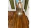 Hallway featuring hardwood floors and white trim that leads to other rooms of the home at 604 N Old Wire Rd, Wildwood, FL 34785