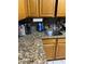 Kitchen counter with granite countertops, stainless steel sink, and modern fixtures at 604 N Old Wire Rd, Wildwood, FL 34785