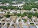 Aerial view of the neighborhood, showcasing mature trees and cozy homes at 616 Third Ave, Lady Lake, FL 32159