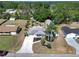 Aerial view of a home with well-kept landscaping, and a long driveway at 616 Third Ave, Lady Lake, FL 32159