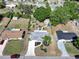 Overhead shot of home featuring mature trees, a long driveway, a garden, and a shed at 616 Third Ave, Lady Lake, FL 32159