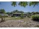 Backyard view of a single-story home with a screened porch and landscaped yard at 616 Third Ave, Lady Lake, FL 32159