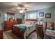 Cozy bedroom with wood furniture, fan, light-blue walls, and a desk area at 616 Third Ave, Lady Lake, FL 32159