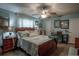 Bright bedroom featuring wood floors, neutral walls, and a wooden bed frame at 616 Third Ave, Lady Lake, FL 32159