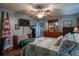 Charming bedroom with hardwood floors, a ceiling fan, and a comfortable bed with decorative pillows at 616 Third Ave, Lady Lake, FL 32159