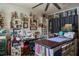 Bright craft room with custom shelving, sewing machine, shiplap accent wall, and lots of natural light at 616 Third Ave, Lady Lake, FL 32159