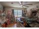 Bright craft room with custom storage shelves, large window, ceiling fan, and sewing and craft supplies at 616 Third Ave, Lady Lake, FL 32159
