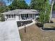 Well-maintained home featuring a manicured lawn, fresh landscaping, and a welcoming walkway at 616 Third Ave, Lady Lake, FL 32159