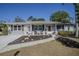 Charming single-story home with a brick accent, walkway, and a lovely landscaped front yard at 616 Third Ave, Lady Lake, FL 32159